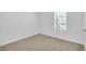 Bedroom with neutral carpet, a window with blinds, and white trim at 14192 Sw 44Th Ct, Ocala, FL 34473