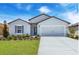 Charming single-story home featuring a well-manicured lawn and a two-car garage at 14192 Sw 44Th Ct, Ocala, FL 34473