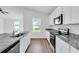 Kitchen features stainless appliances, granite countertops, white cabinetry, and wood-look flooring at 14192 Sw 44Th Ct, Ocala, FL 34473