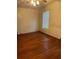 Simple bedroom with hardwood floors, window and standard ceiling fan fixture at 1219 Dixie Dr, Auburndale, FL 33823