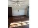 Attic bedroom with hardwood floors, ceiling fan, and decorative leaf border at 1219 Dixie Dr, Auburndale, FL 33823