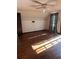 Attic bedroom with hardwood floors, ceiling fan, and small decorative border at 1219 Dixie Dr, Auburndale, FL 33823