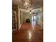 Spacious living room featuring hardwood floors, decorative chandelier and natural lighting at 1219 Dixie Dr, Auburndale, FL 33823