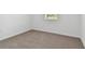 Empty bedroom with neutral carpet, window, and ample closet space at 4837 Foxglove Cir, Lakeland, FL 33811