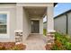 Front entrance with a covered porch and stone accents at 4837 Foxglove Cir, Lakeland, FL 33811