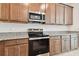 Modern kitchen with stainless steel appliances and granite countertops at 4837 Foxglove Cir, Lakeland, FL 33811