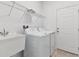 Laundry room with washer, dryer, utility sink, and shelving at 4837 Foxglove Cir, Lakeland, FL 33811