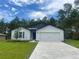 Charming single-story home with a two-car garage, and manicured lawn at 16610 Sw 50Th Cir, Ocala, FL 34473