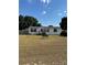 Single-wide manufactured home with a spacious yard at 4316 Upper Meadow Rd, Mulberry, FL 33860