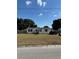 Single-wide manufactured home with a spacious yard at 4316 Upper Meadow Rd, Mulberry, FL 33860