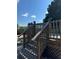 Wooden deck stairs leading up to a backyard deck with railing at 4316 Upper Meadow Rd, Mulberry, FL 33860
