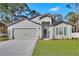 Charming one-story home featuring a two-car garage and a beautifully maintained front yard at 15271 Sw 65Th Terrace Rd, Ocala, FL 34473