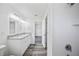 Well-lit bathroom featuring a double sink vanity, shower, and luxury vinyl plank flooring at 2700 Laguna Dr, Indian Lake Estates, FL 33855