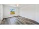 Bright bedroom with window, ceiling fan and neutral walls at 2700 Laguna Dr, Indian Lake Estates, FL 33855
