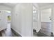 Hallway featuring hard surface floors with white walls and doors at 2700 Laguna Dr, Indian Lake Estates, FL 33855