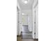 Hallway featuring hard surface floors with white walls and doors at 2700 Laguna Dr, Indian Lake Estates, FL 33855