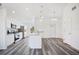 Kitchen with white cabinets, stainless steel appliances, granite countertops, and vinyl floors at 2700 Laguna Dr, Indian Lake Estates, FL 33855