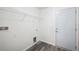 Clean laundry room with a door, wire rack, and gray luxury vinyl plank flooring at 2700 Laguna Dr, Indian Lake Estates, FL 33855