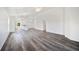 Living room featuring vinyl floors with bright white walls, ceiling fan, and open floor plan at 2700 Laguna Dr, Indian Lake Estates, FL 33855