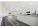 Open floor plan featuring vinyl floors with bright white walls, and stainless steel appliances at 2700 Laguna Dr, Indian Lake Estates, FL 33855