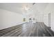 Living room featuring vinyl floors with bright white walls, ceiling fan, and open floor plan at 2700 Laguna Dr, Indian Lake Estates, FL 33855
