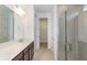 Bathroom with double vanity, a large mirror, and a glass shower at 4390 Sw 84Th Street Rd, Ocala, FL 34476