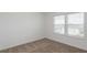 Well-lit bedroom featuring neutral carpet and window at 4390 Sw 84Th Street Rd, Ocala, FL 34476