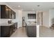 Modern kitchen with dark brown cabinets, stainless steel appliances, and an island at 4390 Sw 84Th Street Rd, Ocala, FL 34476
