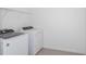 Bright laundry room with washer, dryer, and shelving at 4390 Sw 84Th Street Rd, Ocala, FL 34476
