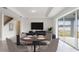 Bright living room features a dining table, couch, and a sliding glass door to the backyard at 4390 Sw 84Th Street Rd, Ocala, FL 34476