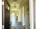 Elegant hallway with decorative light fixture, tiled floors, and view to living area at 7771 Lake James Blvd, Lakeland, FL 33810