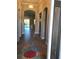 Inviting hallway with tile floors, arched doorways, and view to the living room at 7771 Lake James Blvd, Lakeland, FL 33810