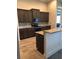 Modern kitchen with granite countertops, stainless steel appliances, and dark wood cabinets at 7771 Lake James Blvd, Lakeland, FL 33810