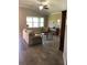 Cozy living room with large windows, tile floors, and comfortable furnishings at 7771 Lake James Blvd, Lakeland, FL 33810