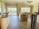 Open living room featuring tile floors, large windows, and access to outdoor space at 7771 Lake James Blvd, Lakeland, FL 33810