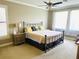 Serene main bedroom with carpet, a large window, ceiling fan, and neutral wall color at 7771 Lake James Blvd, Lakeland, FL 33810
