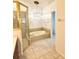Bathroom featuring a soaking tub, tiled floors, and a glass shower enclosure at 5446 Pebble Beach Dr, Lakeland, FL 33812