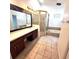 Bathroom features double sink vanity, glass shower, and separate soaking tub at 5446 Pebble Beach Dr, Lakeland, FL 33812