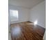 This bedroom features wood floors, a window, and natural light at 5446 Pebble Beach Dr, Lakeland, FL 33812