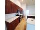 Modern kitchen with stainless steel appliances, sleek white countertops, and rich dark wood cabinets at 5446 Pebble Beach Dr, Lakeland, FL 33812