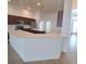 Spacious kitchen features dark wood cabinetry, stainless steel appliances, and a large wraparound island at 5446 Pebble Beach Dr, Lakeland, FL 33812