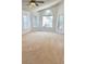 Inviting living room with vaulted ceilings, natural light, and neutral carpeting at 5446 Pebble Beach Dr, Lakeland, FL 33812