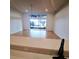 Bright living room with tile floor and sliding glass doors leading to a screened lanai, ideal for indoor/outdoor living at 5446 Pebble Beach Dr, Lakeland, FL 33812