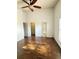 Main bedroom with wood look floors, ensuite bathroom access, and a ceiling fan at 5446 Pebble Beach Dr, Lakeland, FL 33812