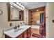 Tiled bathroom with a large mirror, vanity, and a shower-tub combination at 22134 Obrien Rd, Howey In The Hills, FL 34737