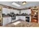 Charming kitchen with white cabinets, a modern backsplash, and stainless steel appliances at 22134 Obrien Rd, Howey In The Hills, FL 34737