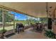 Enclosed patio with outdoor seating, grill, and views of the surrounding landscape at 22134 Obrien Rd, Howey In The Hills, FL 34737