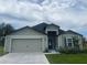 Single-story home featuring a welcoming entrance and an attached two-car garage at 4423 Sw 171St Pl, Ocala, FL 34473