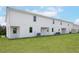Townhomes with a green backyard and AC units at 567 Bay Leaf Dr, Poinciana, FL 34759