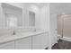 Bathroom featuring dual vanity sinks and a glass enclosed shower at 567 Bay Leaf Dr, Poinciana, FL 34759